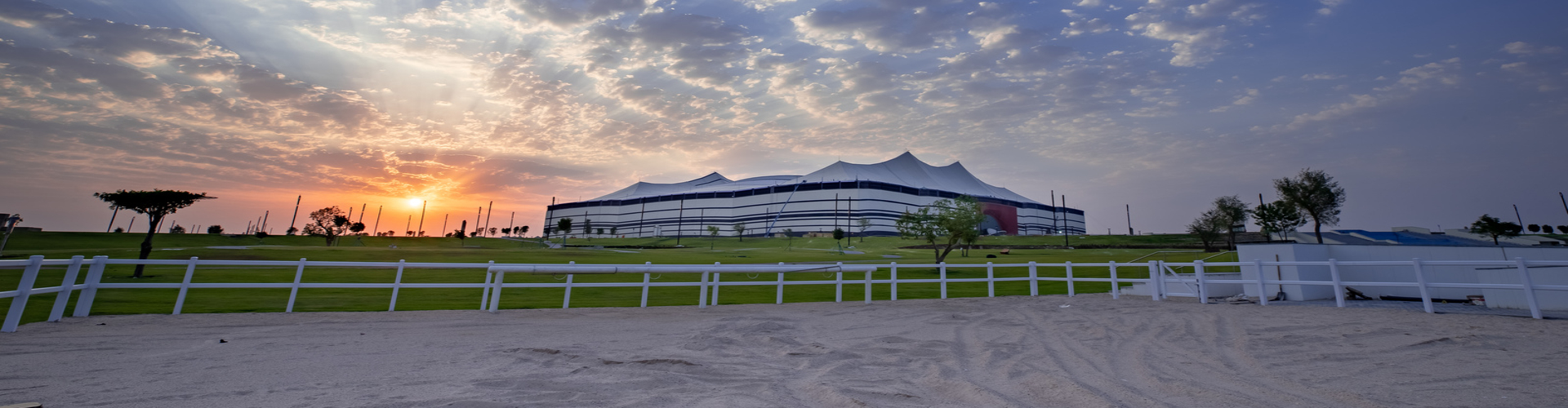 Al Bayt Stadium at sunset.