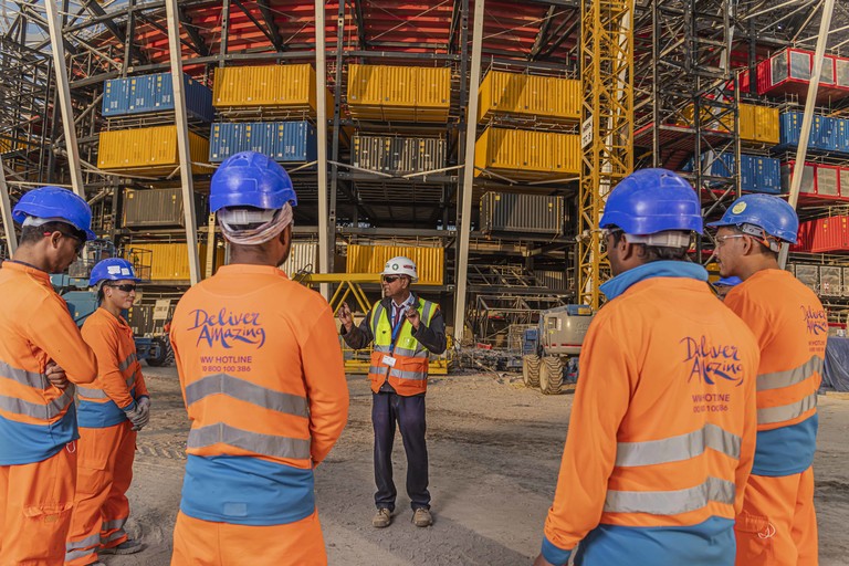 A contractor with workers at the Ras Abu Aboud Stadium